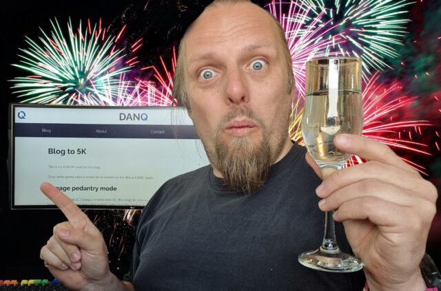 Dan with a champagne flute, fireworks in the background, points to a screen showing this blog post.